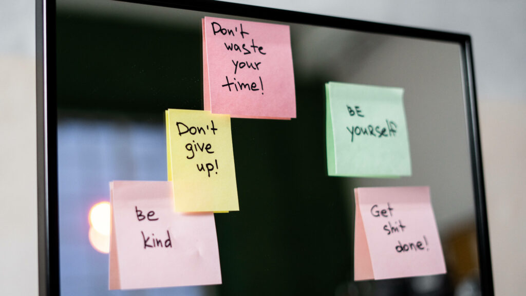 Colorful Sticky Notes for Motivation on Reflective Background Wallpaper