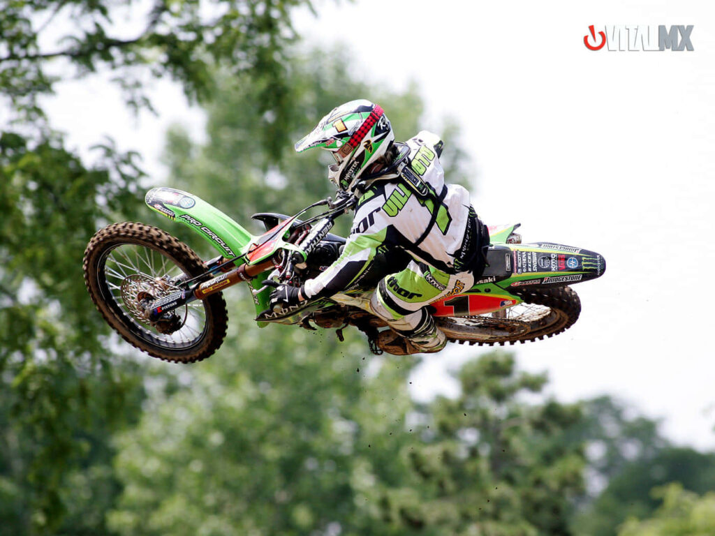 Vibrant Motocross Action Wallpaper: Rider Mid-Air on Dirt Bike