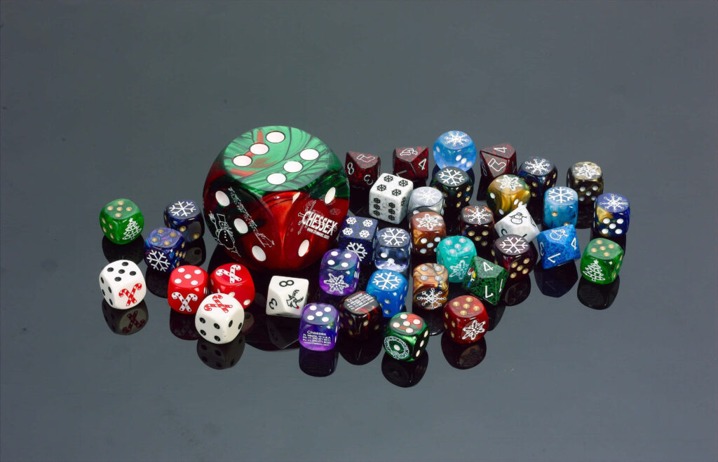 Vibrant multi-colored dice with intricate designs on glossy black surface featuring green red die Wallpaper