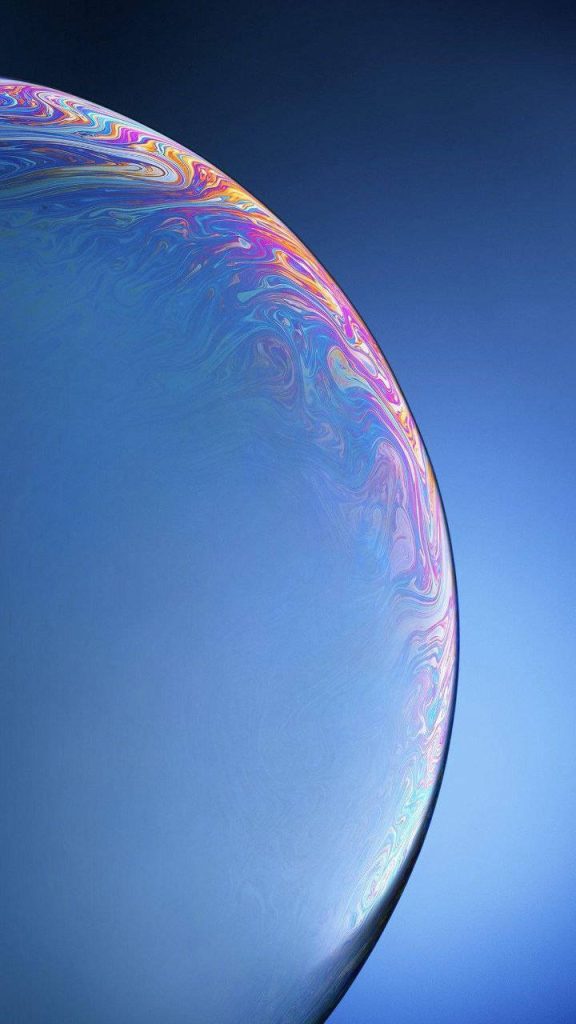 Vibrant iPhone XR wallpaper colorful soap bubble with iridescent rainbow edges on blue background