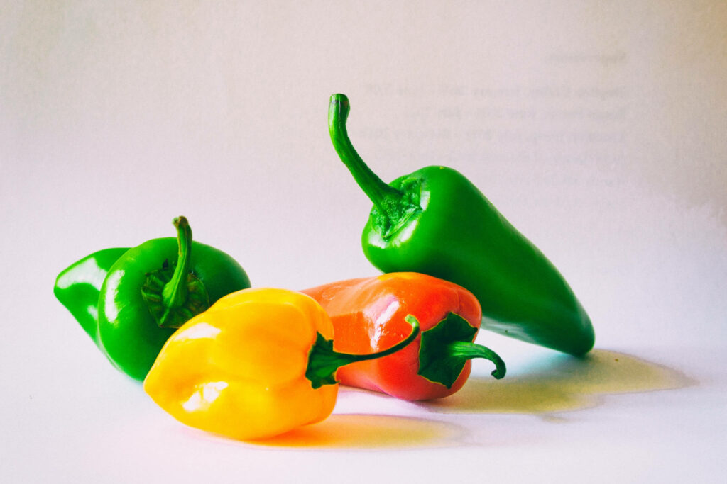 Vibrant Multicolored Bell Peppers Wallpaper on Textured Gray Background