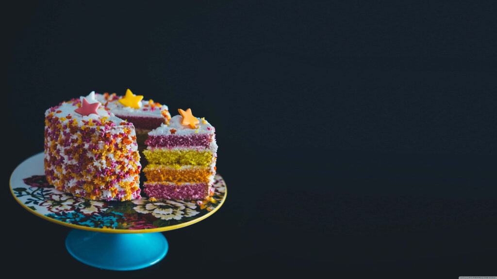 Vibrant Multicolored Cake Wallpaper with Star Decorations & Sprinkles