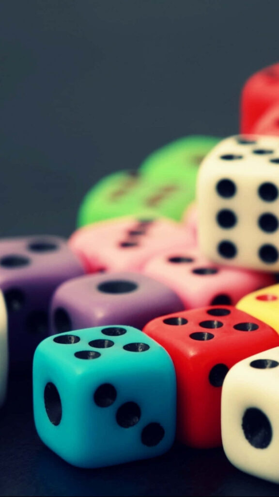Vibrant multicolored glossy dice stack with sharp dots on dark blurred background gaming wallpaper
