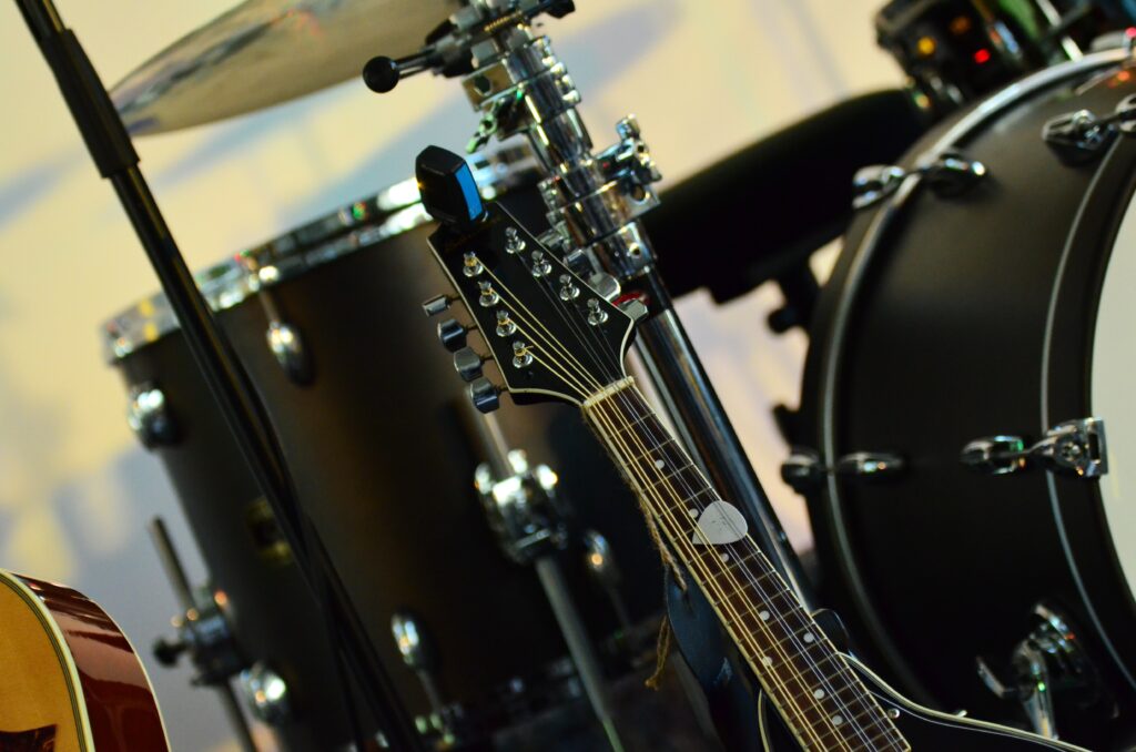 Vibrant Musical Instruments Wallpaper: Guitar & Drum Set Harmony