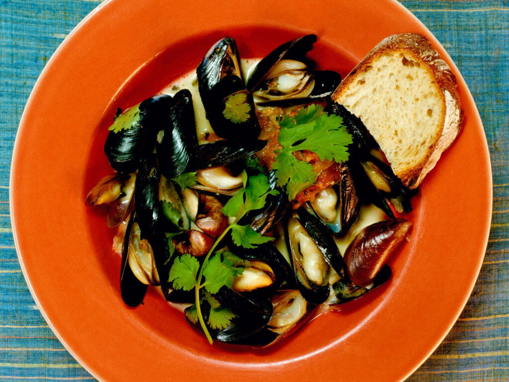 Vibrant Mussel Dish with Tomatoes & Herbs on Toasted Bread Wallpaper