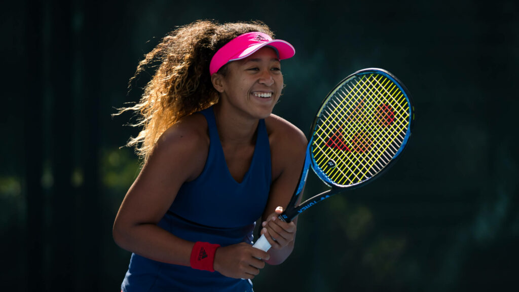 Naomi Osaka Smiling Wallpaper: Joyful Tennis Passion Background