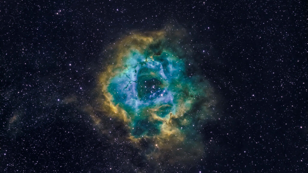 Stunning nebula wallpaper in blue, green, and yellow, adorned with sparkling stars in the endless expanse of space.