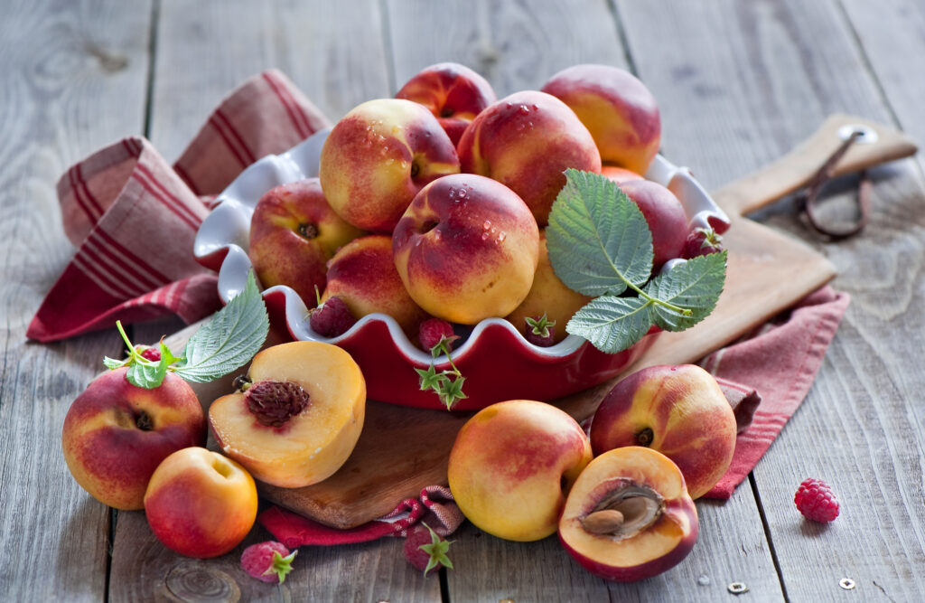 Vibrant Nectarines & Raspberries on Decorative Plate - Wholesome Wallpaper