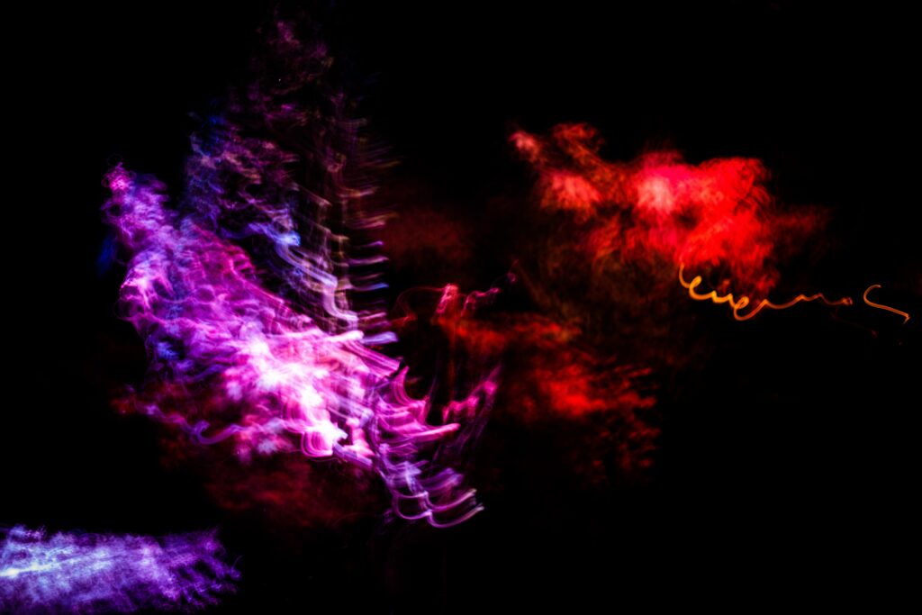 Vibrant Neon Abstract Wallpaper: Swirling Purple and Red Design