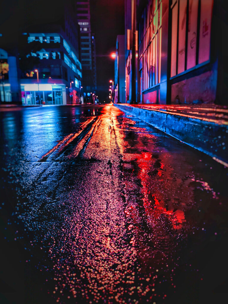 Vibrant Neon Cityscape: Moody Wet Street Wallpaper Background