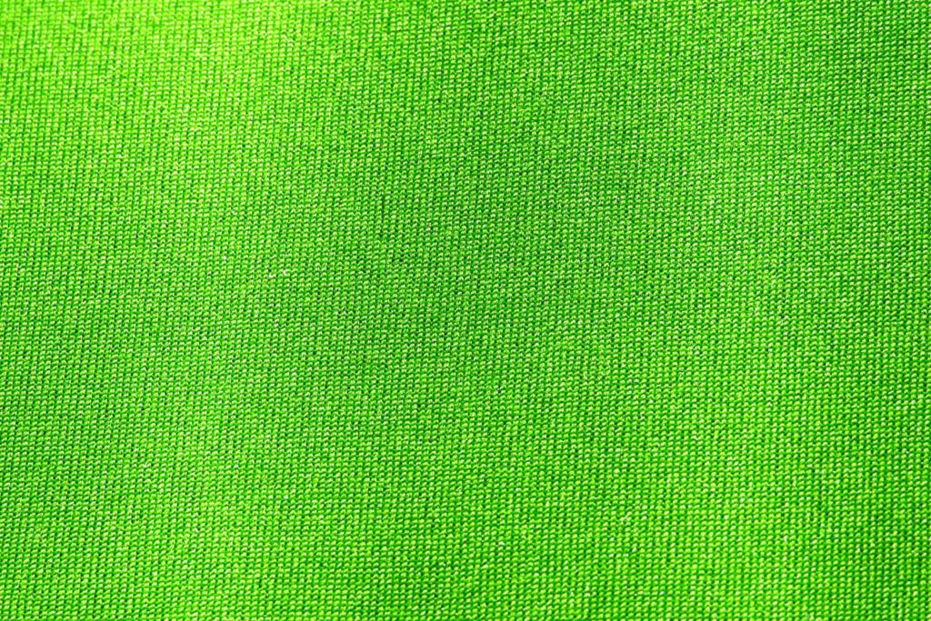 Vibrant Neon Green Fabric Texture Wallpaper Background