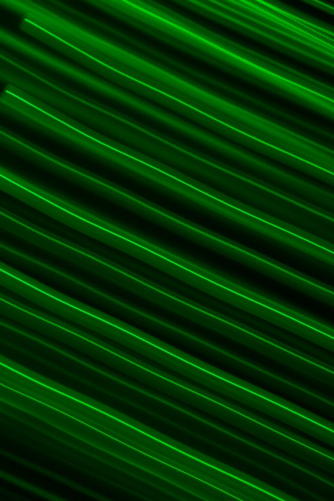 Vibrant Neon Green Stripes Wallpaper on Dark Background