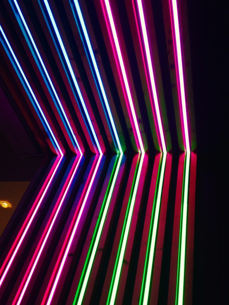 Vibrant Neon Stripes Geometric Wallpaper on Dark Background