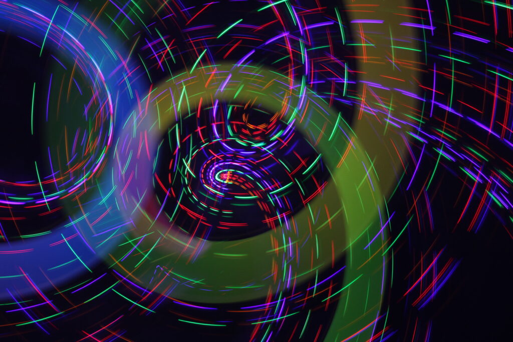 Vibrant Neon Light Strips Swirling Background Wallpaper