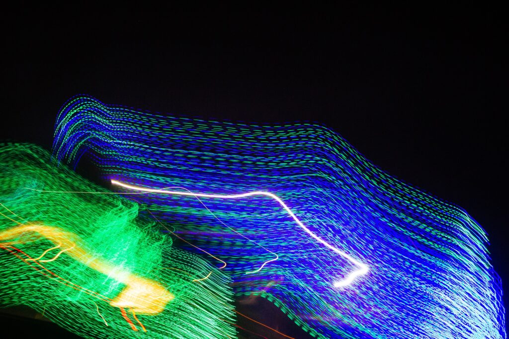 Vibrant Neon Light Trails Wallpaper: Long Exposure Art in Dark Background