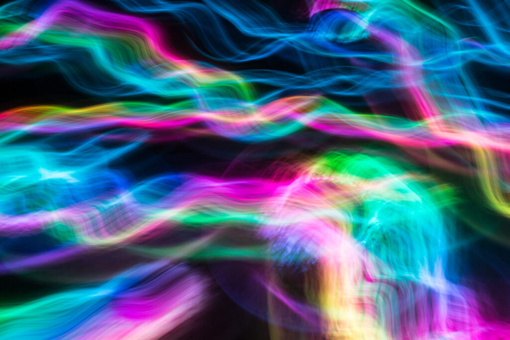 Vibrant Neon Light Trails Wallpaper on Black Background
