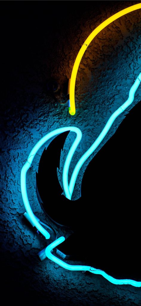 Vibrant cyan and yellow neon tubes on dark textured wall abstract wallpaper for iPhone display