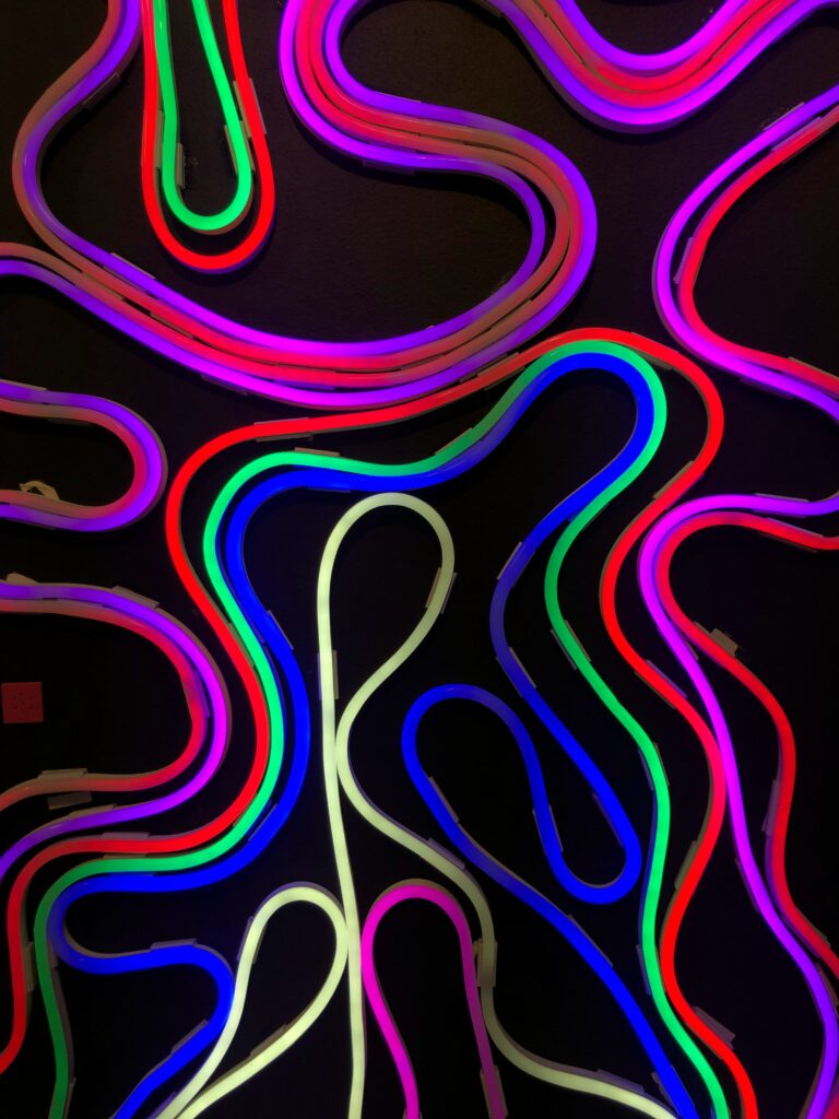 Vibrant Neon Lines Wall Art: Colorful Stripes on Dark Background Wallpaper