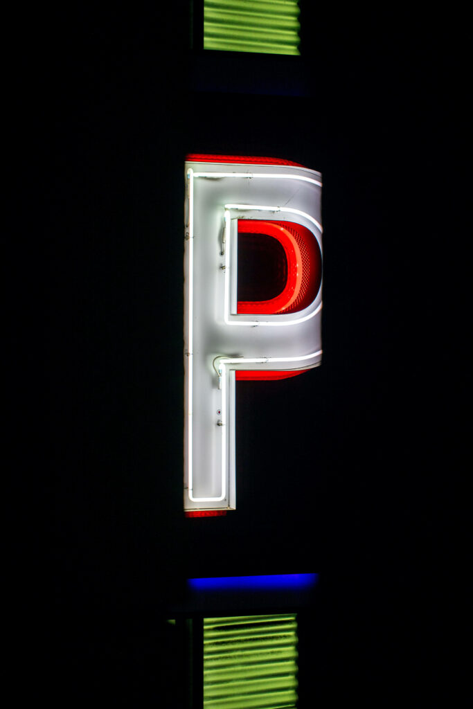 Eye-Catching Neon Letter P Sign on Dark Background Wallpaper