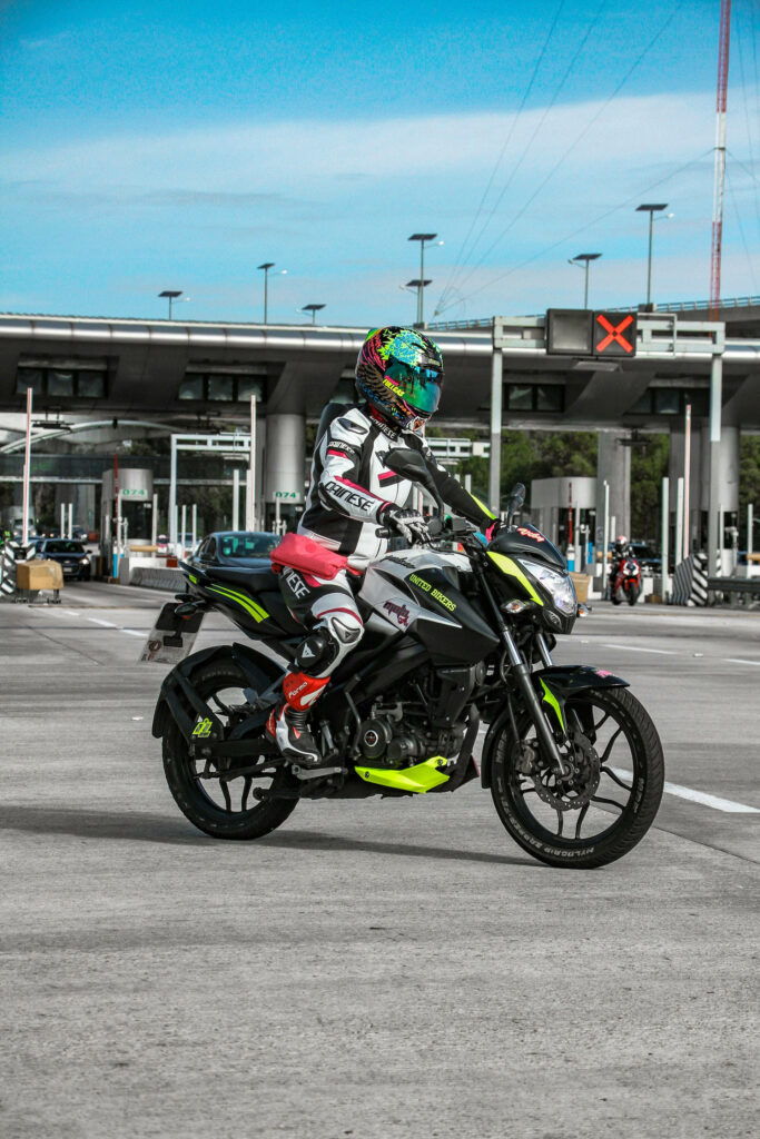 Vibrant Neon Pulsar RS200 Motorcycle Wallpaper with Racing Rider