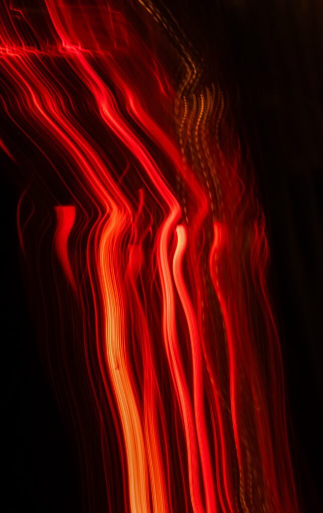 Vibrant Neon Red Light Trails Wallpaper - Mesmerizing Background