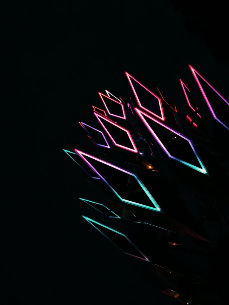 Vibrant Neon Rhombus Shapes Wallpaper on Black Background