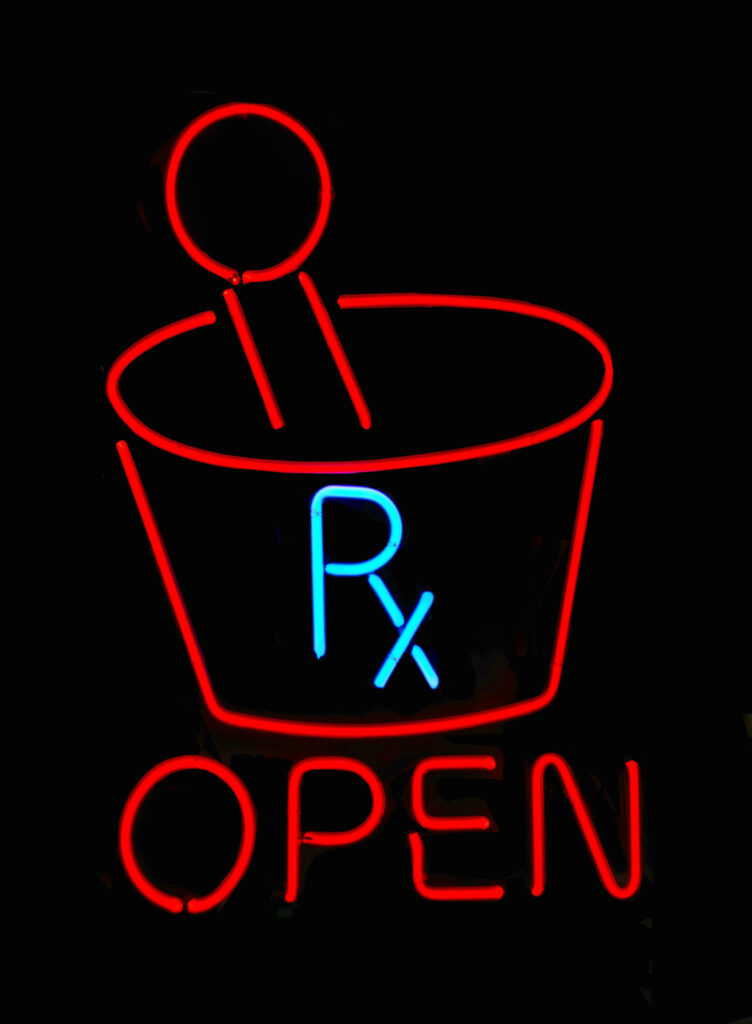 Energized Glow: Illuminated Medical Symbol Rx Shines Against Black Background Wallpaper