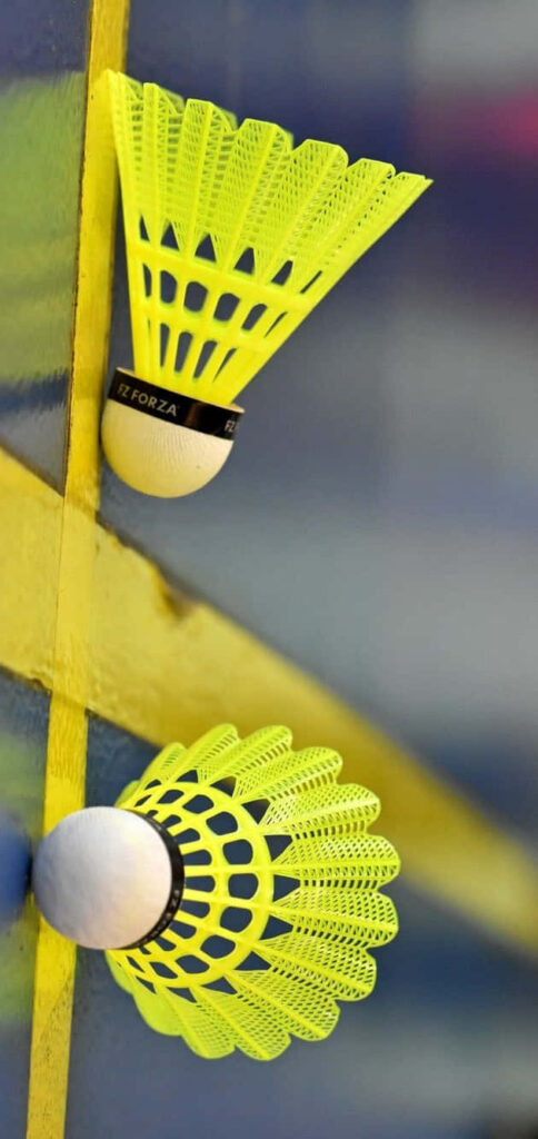 Vibrant Shuttlecocks: Illuminating the Polished Badminton Court Wallpaper