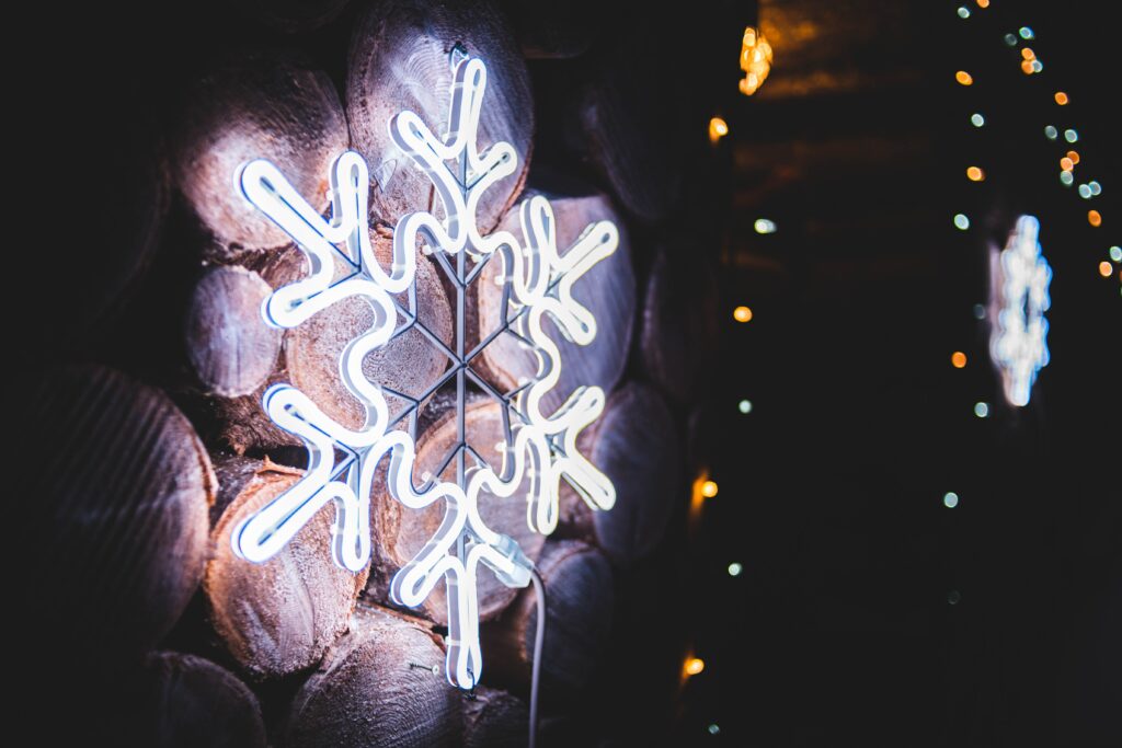 Vibrant Neon Snowflake Wallpaper on Rustic Wood Background