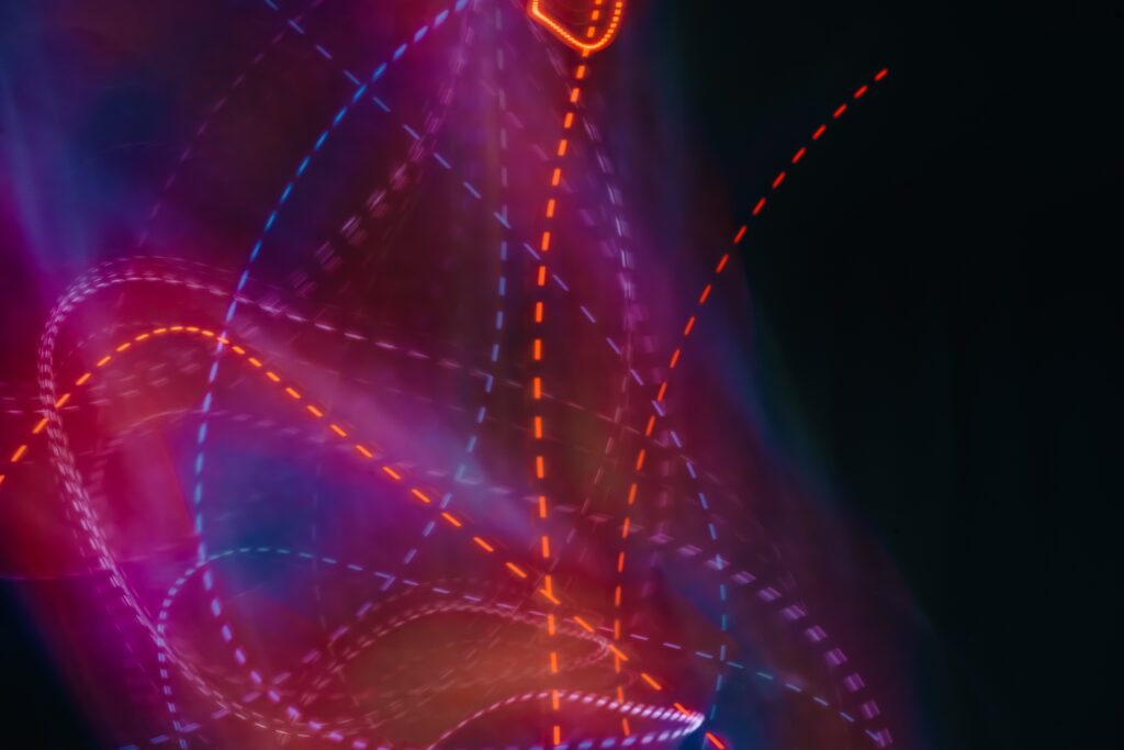 Vibrant Neon Wallpaper: Colorful Lines Blur Against Dark Background