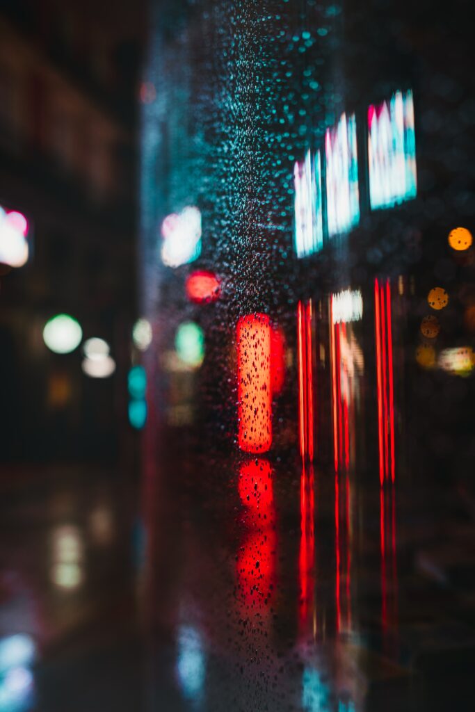 Vibrant Neon Wallpaper: Glass with Water Droplets & Colorful Reflections