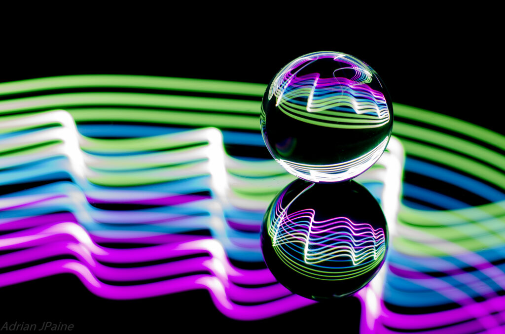 Vibrant Neon Wallpaper: Glowing Ball & Intricate Light Patterns