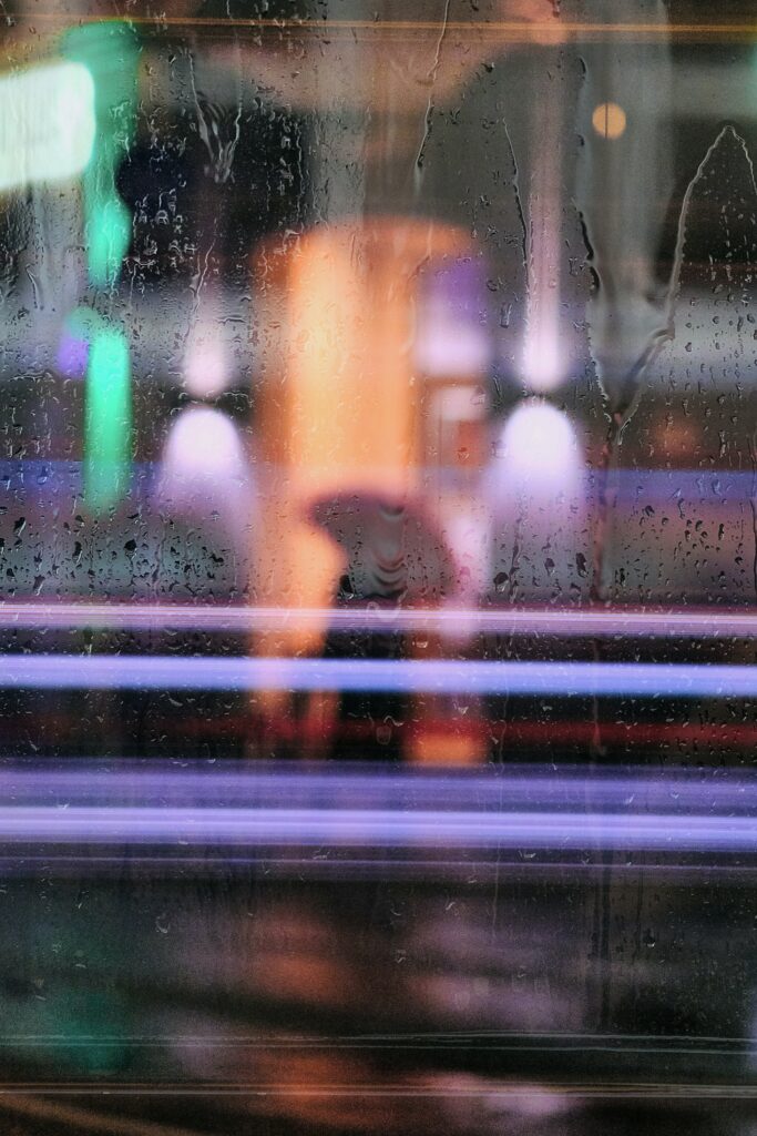 Neon-Lit Wallpaper: Reflective Aesthetics with Rain-Soaked Glass