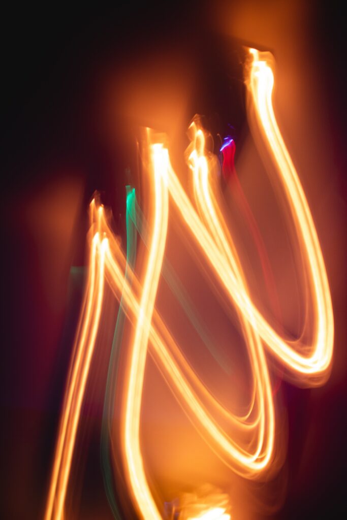 Dynamic Neon Wavy Lines Wallpaper: Vibrant Glow on Dark Background