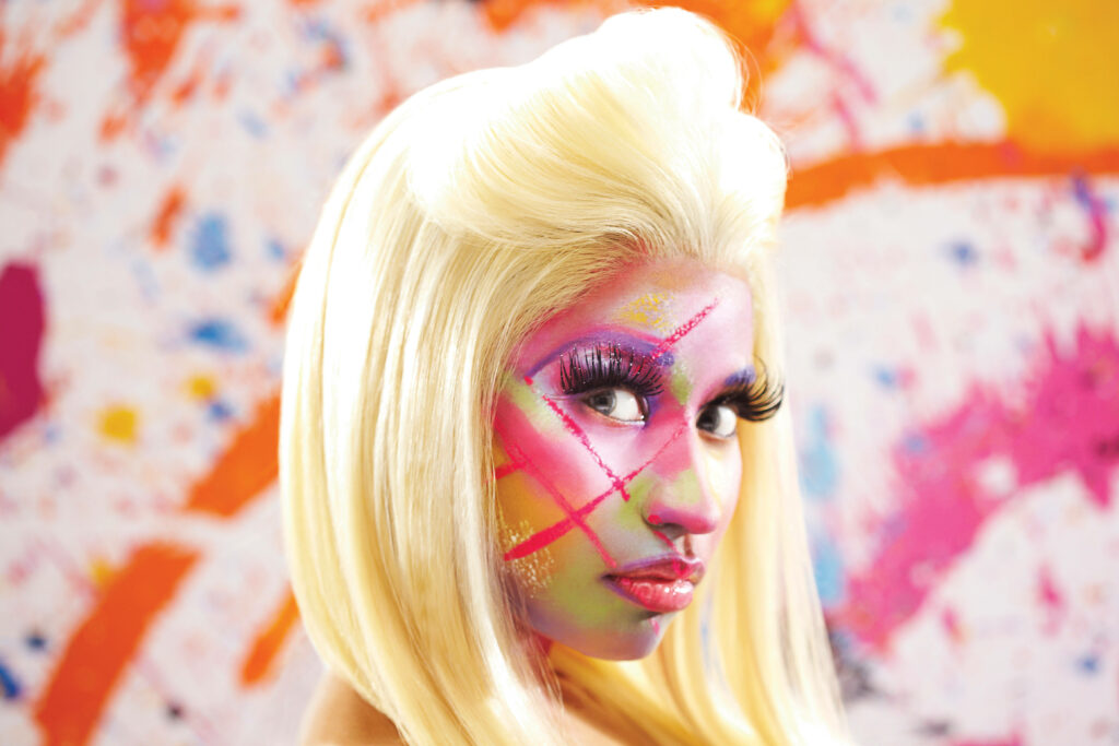 Vibrant Nicki Minaj Wallpaper: Bold Face Paint & Abstract Background