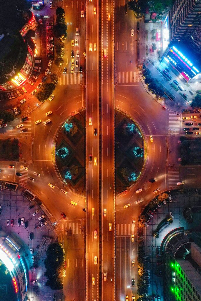 Vibrant Aerial City Intersection Wallpaper: Neon Lights at Night