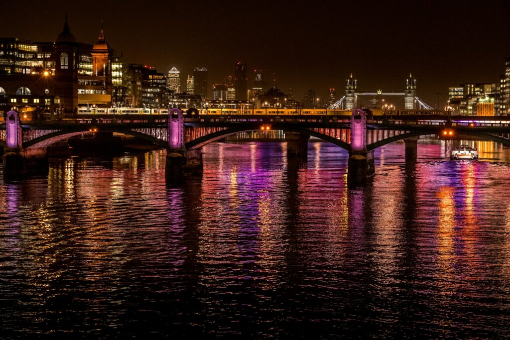Vibrant Night Cityscape Wallpaper: Illuminated Bridge & Reflections