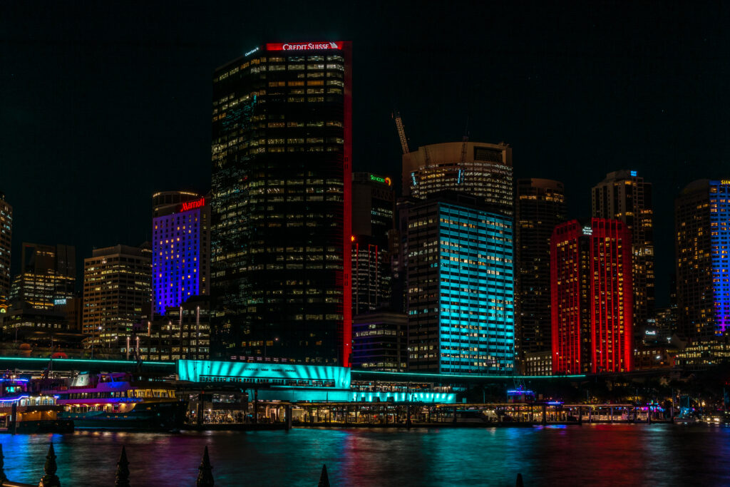 Vibrant Night Cityscape Wallpaper: Urban Life Reflected in Water