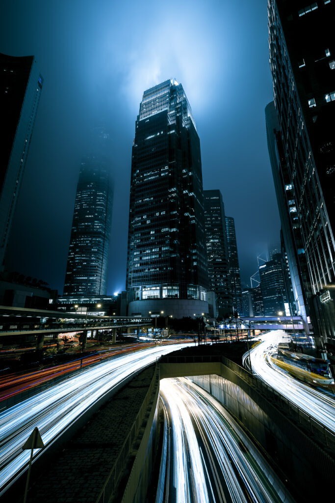 Vibrant Night Cityscape Wallpaper: Skyscrapers & Light Trails
