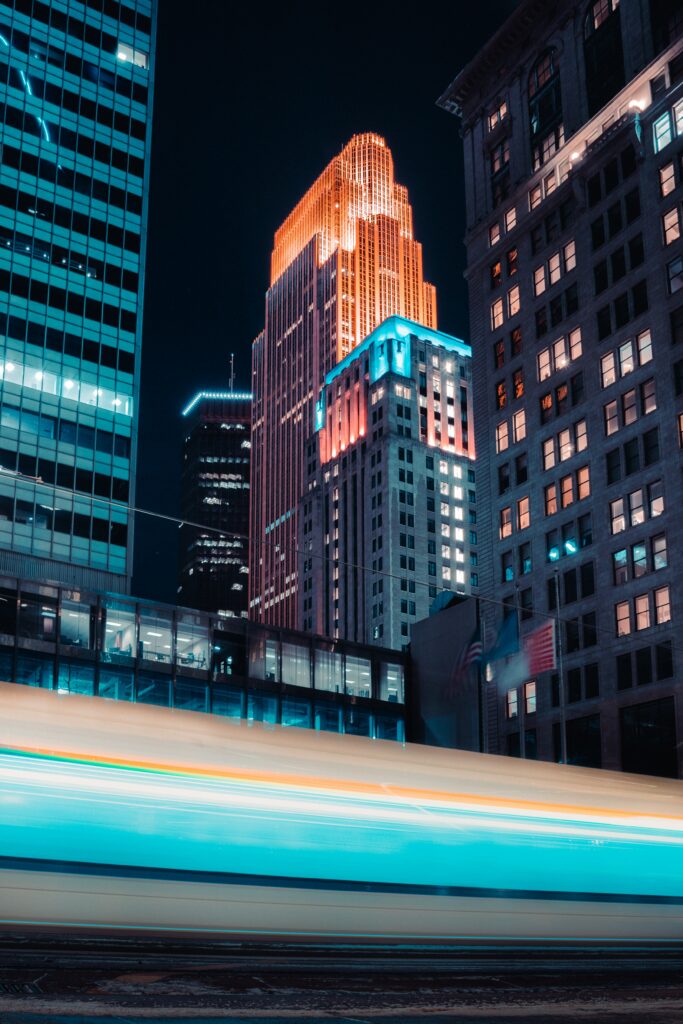 Vibrant Night Cityscape Wallpaper with Glowing Lights and Vehicle Streaks