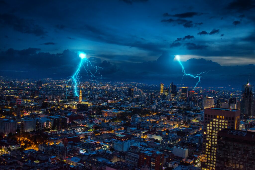 Vibrant Night Cityscape Wallpaper with Lightning and Glowing Lights