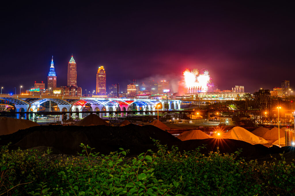 Vibrant Nighttime Cityscape Wallpaper with Fireworks Display
