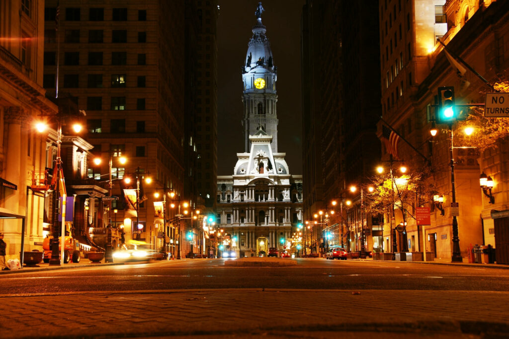 Vibrant City Clock Tower Night View - Illuminated Wallpaper Background