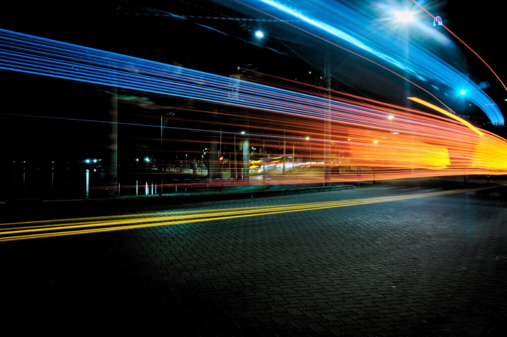 Vibrant Nighttime City Scene Wallpaper with Colorful Light Streaks