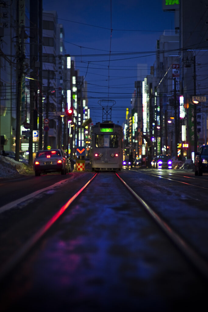 Vibrant Nighttime Cityscape Wallpaper: Tranquil Street & Glowing Trams