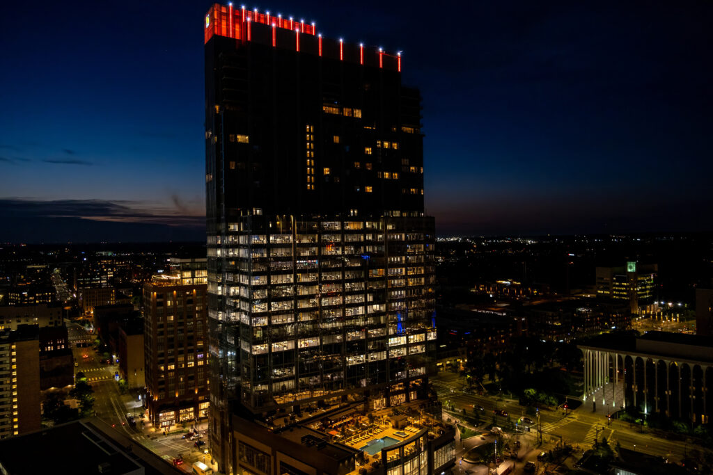 Vibrant Nighttime Cityscape Wallpaper: Modern Building & Urban Lights