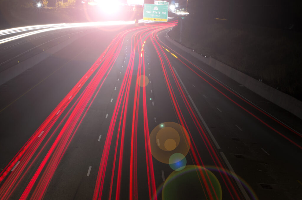 Vibrant Nighttime Highway Wallpaper with Light Trails & Road Markings