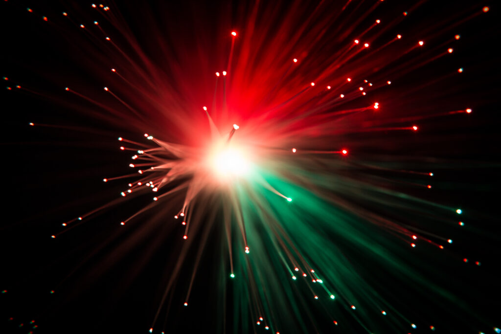 Vibrant Red & Green Optical Fiber Wallpaper Background with Sparks