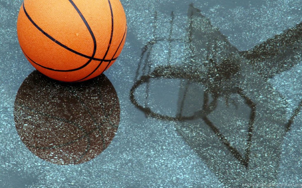 Vibrant orange basketball on wet pavement with hoop silhouette and clear reflection wallpaper