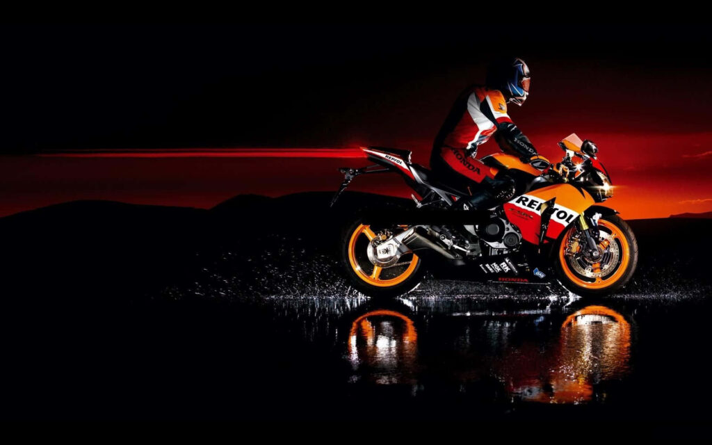 Vibrant Orange & Black Motorcycle Wallpaper Against Sunset Backdrop